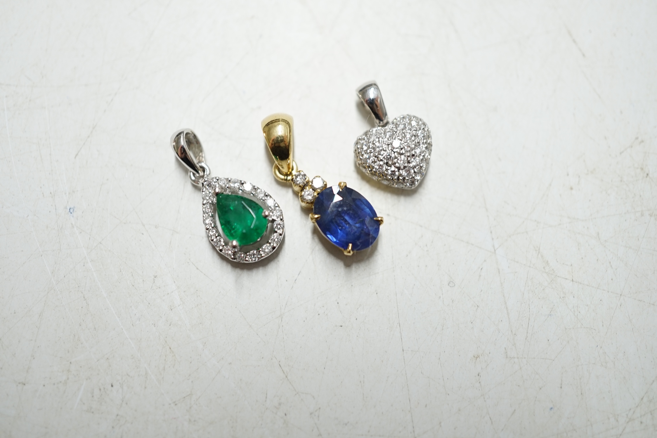 Three assorted modern 18k and gem set small pendants, including heart shape diamond cluster, gross weight 4.5 grams. Condition - fair to good